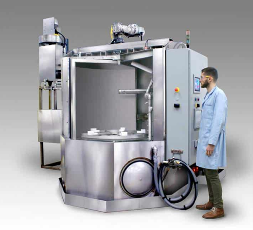 Industrial aqueous parts washer using aqueous parts washer detergent for precision component cleaning.