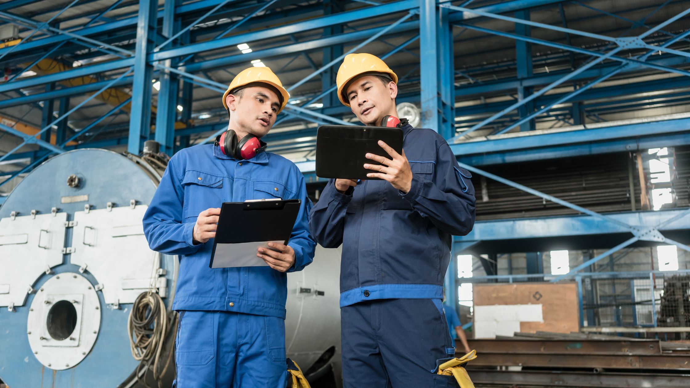 Engineers reviewing an industrial parts washing process to improve manufacturing quality and audit compliance.