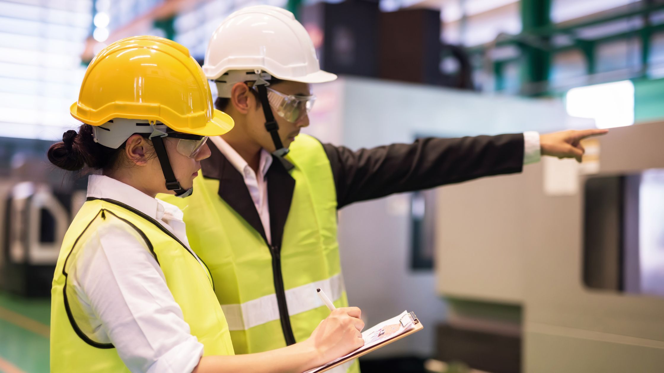 Engineers reviewing manufacturing processes while assessing OEM-Approved Cleaning Chemistry for audit compliance.